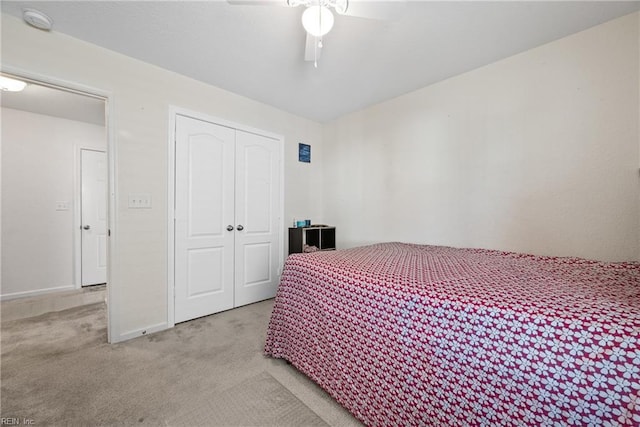 carpeted bedroom featuring a closet and ceiling fan