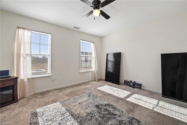 interior space featuring ceiling fan and light colored carpet