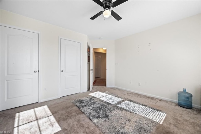 unfurnished bedroom with ceiling fan and light carpet