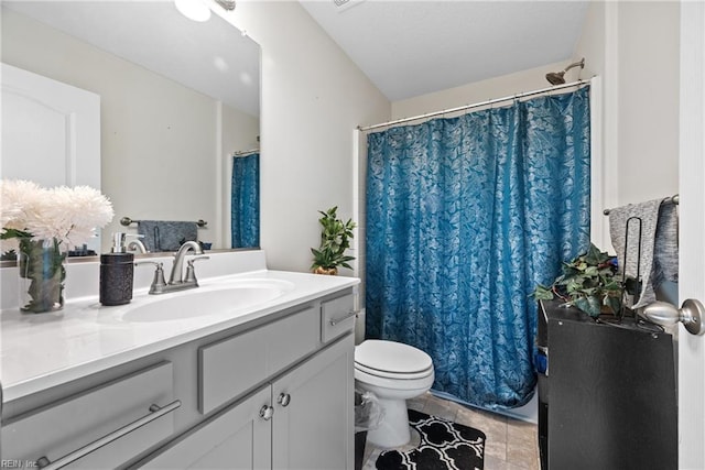 bathroom featuring tile patterned flooring, vanity, and toilet