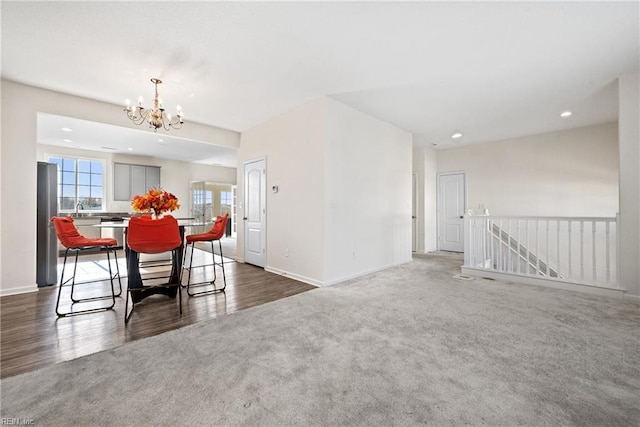 dining space with a chandelier and dark wood-type flooring