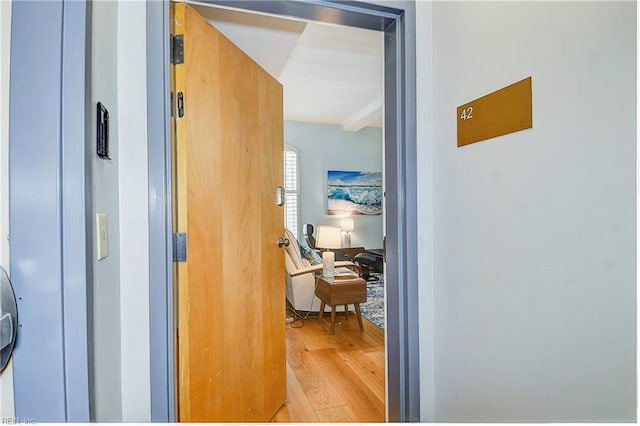 hallway with light hardwood / wood-style flooring