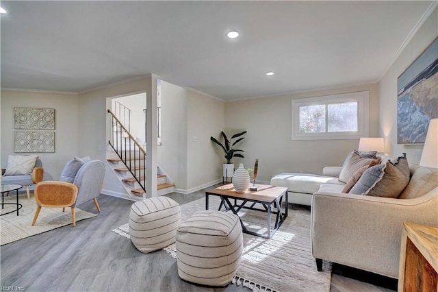 living room featuring ornamental molding and light wood-type flooring