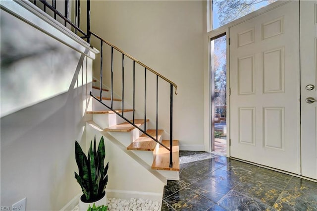 foyer entrance featuring a towering ceiling