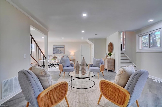 living room featuring crown molding and hardwood / wood-style flooring