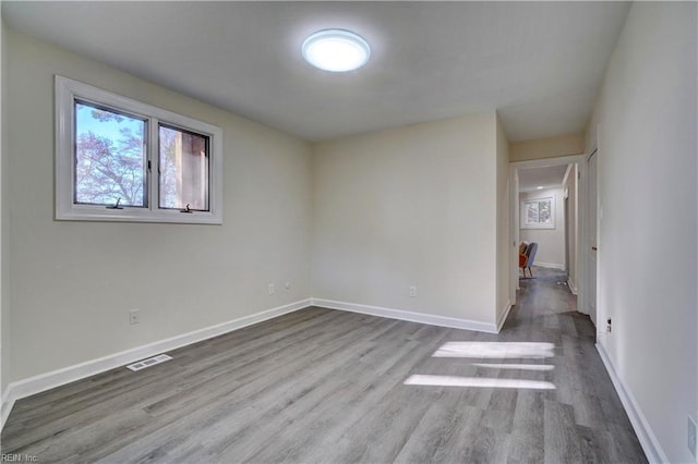 spare room with hardwood / wood-style flooring