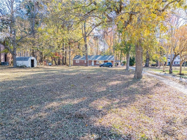 single story home with a storage shed