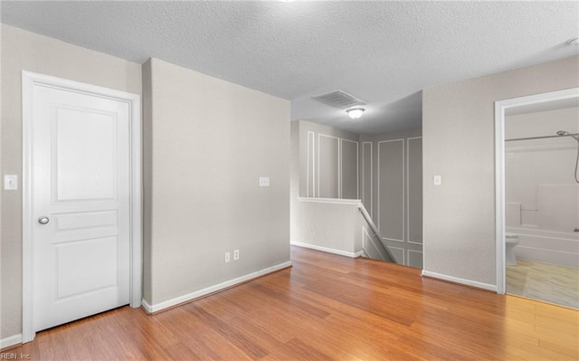 interior space featuring hardwood / wood-style flooring and a textured ceiling