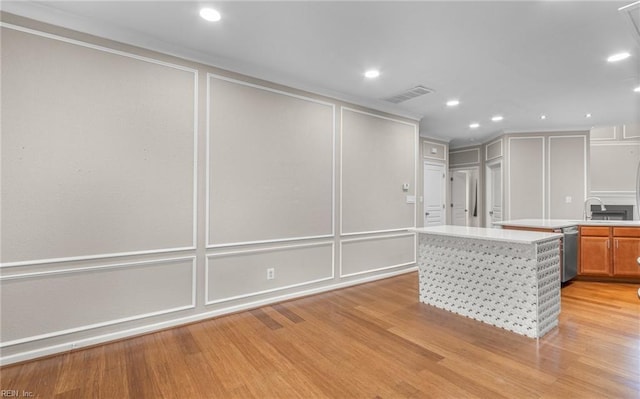 kitchen featuring light wood-type flooring, white fridge, stainless steel dishwasher, and sink