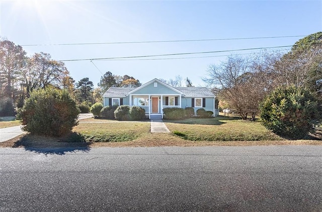 view of front of property with a porch and a front yard