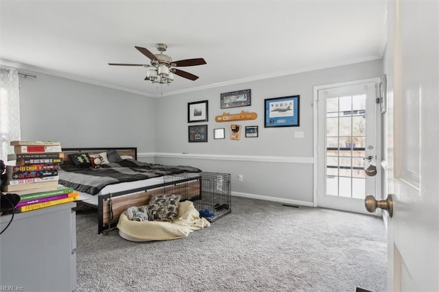 carpeted bedroom with ceiling fan and crown molding