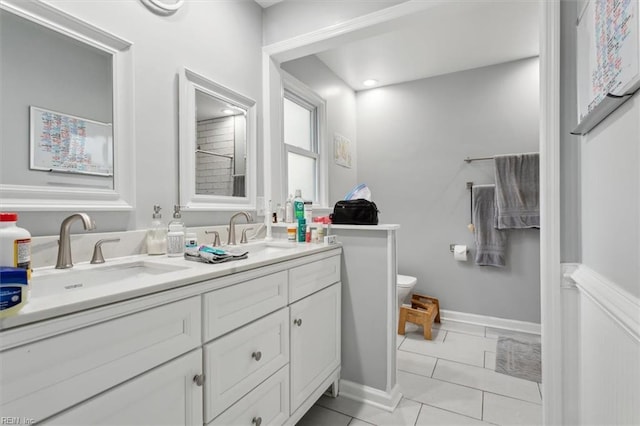 bathroom featuring tile patterned flooring, vanity, and toilet