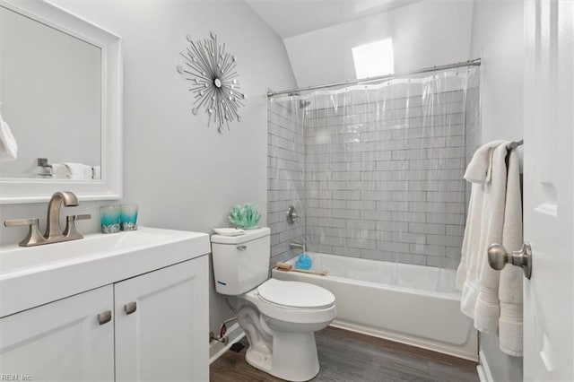 full bathroom with hardwood / wood-style floors, vanity, shower / tub combo, and toilet