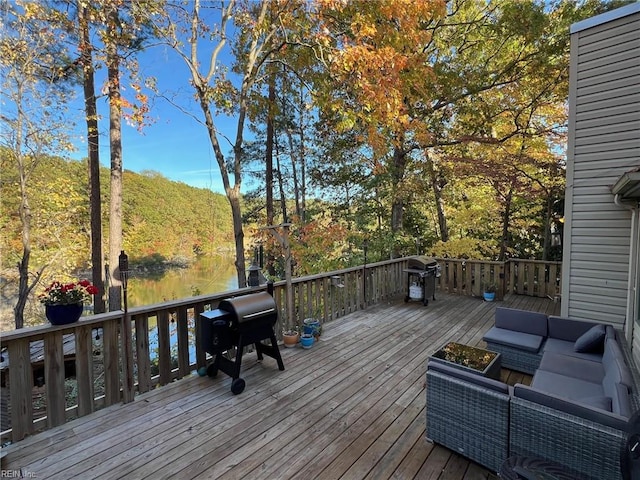 deck featuring grilling area, an outdoor living space, and a water view