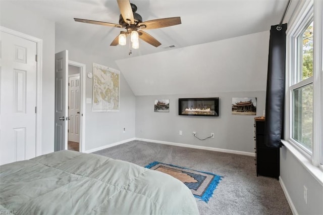 bedroom featuring ceiling fan, carpet floors, and vaulted ceiling