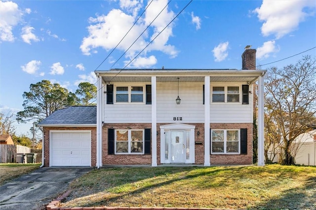 view of front of house featuring a garage and a front yard