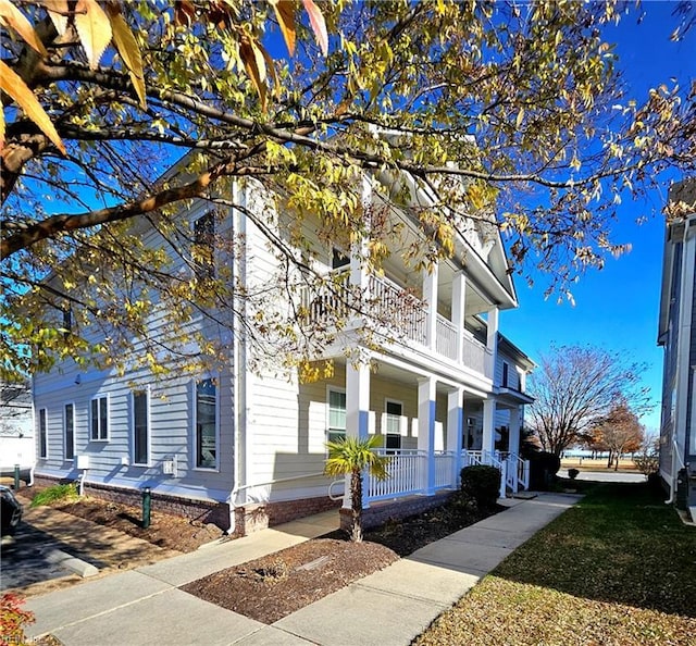 view of front of home featuring covered porch and a balcony