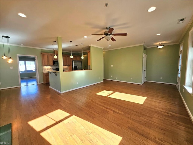 unfurnished living room featuring crown molding, dark hardwood / wood-style flooring, and ceiling fan