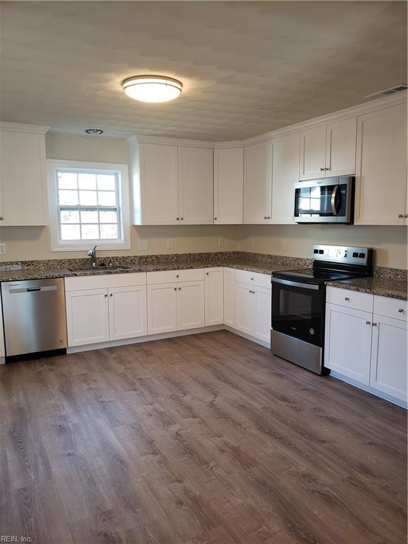 kitchen featuring white cabinets, dark hardwood / wood-style floors, and appliances with stainless steel finishes