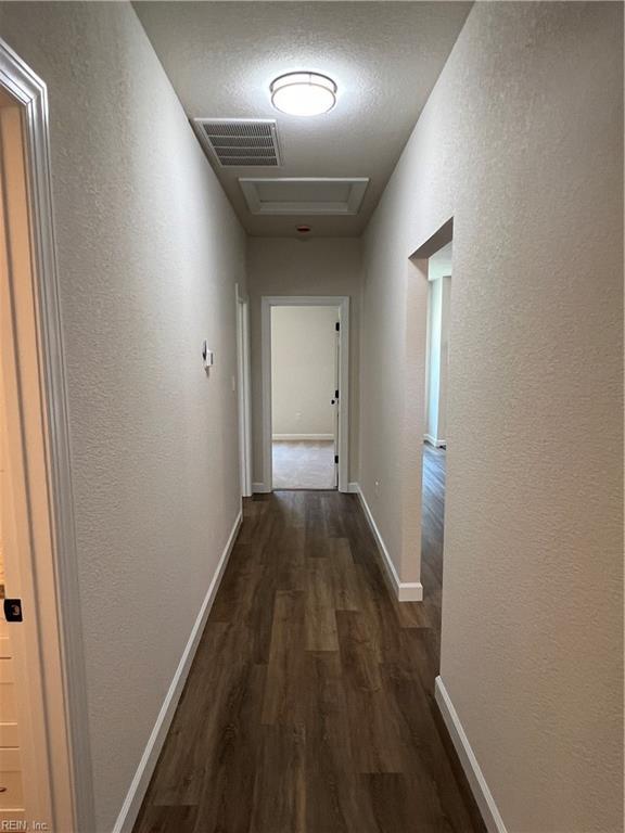 hallway with dark hardwood / wood-style floors