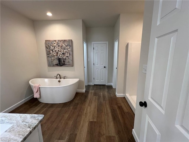 bathroom with vanity, independent shower and bath, and hardwood / wood-style flooring