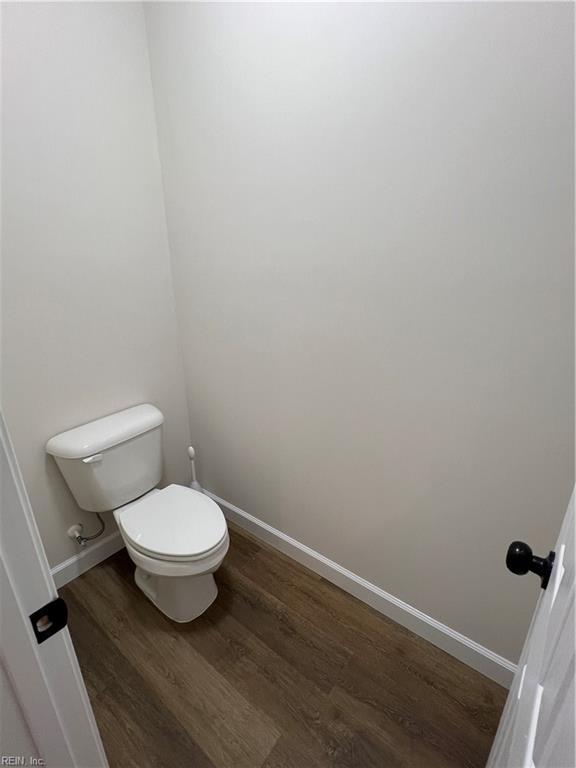 bathroom with wood-type flooring and toilet