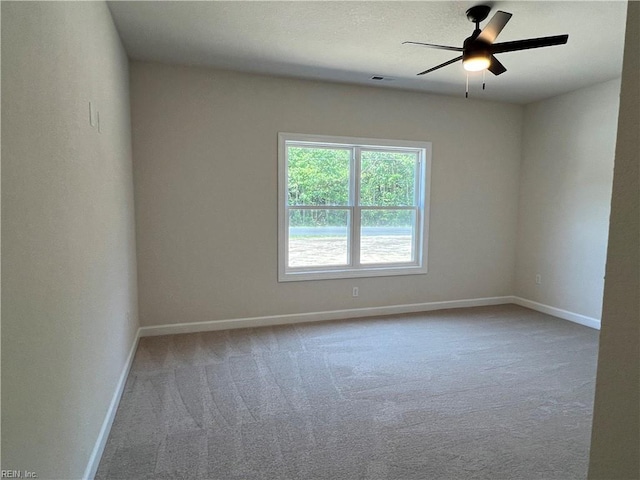 empty room featuring carpet flooring and ceiling fan