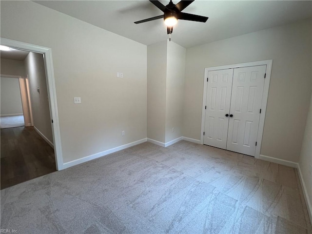 unfurnished bedroom with a closet, ceiling fan, and light colored carpet