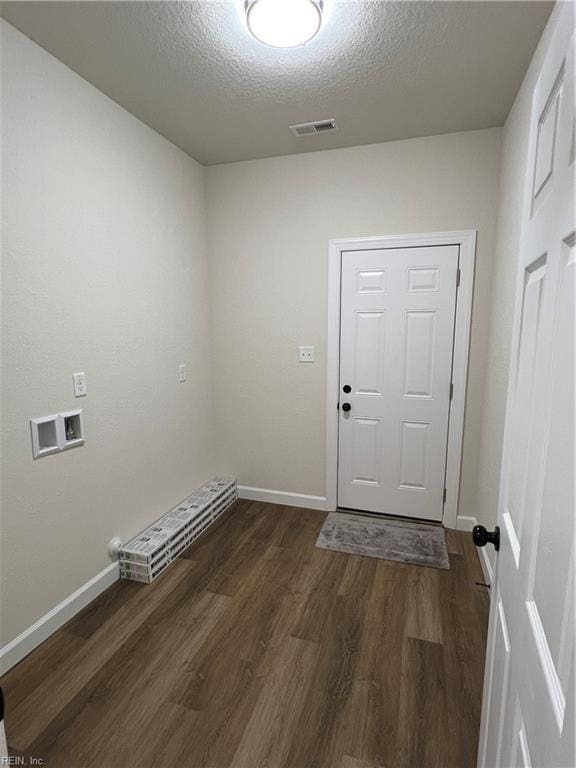 washroom featuring a textured ceiling, washer hookup, and dark hardwood / wood-style floors