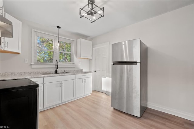 kitchen featuring white cabinets, pendant lighting, sink, and appliances with stainless steel finishes