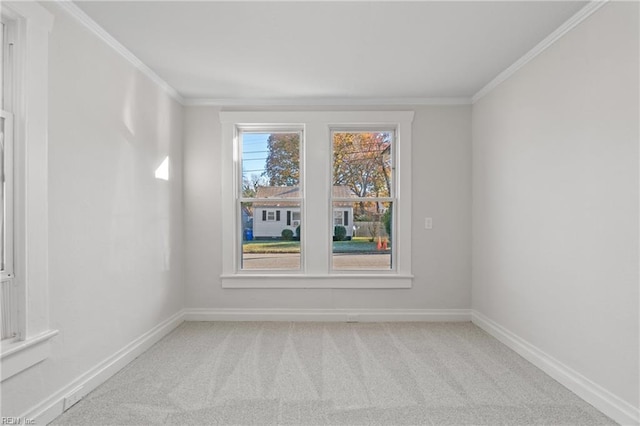 unfurnished room with light colored carpet and crown molding