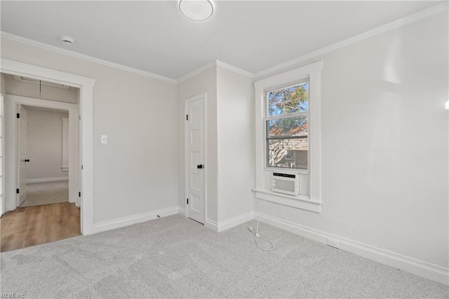 unfurnished bedroom featuring cooling unit, light colored carpet, and crown molding