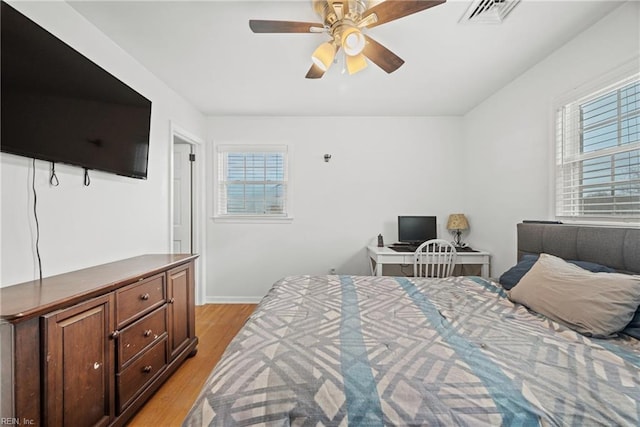 bedroom with ceiling fan and light hardwood / wood-style floors