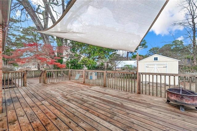 deck featuring a fire pit and a storage shed