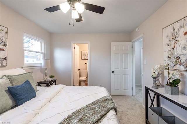 carpeted bedroom with ceiling fan and connected bathroom