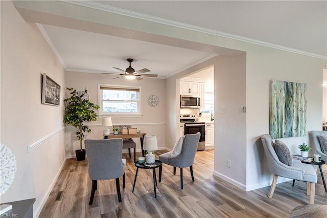 dining space featuring light hardwood / wood-style flooring, ceiling fan, and crown molding