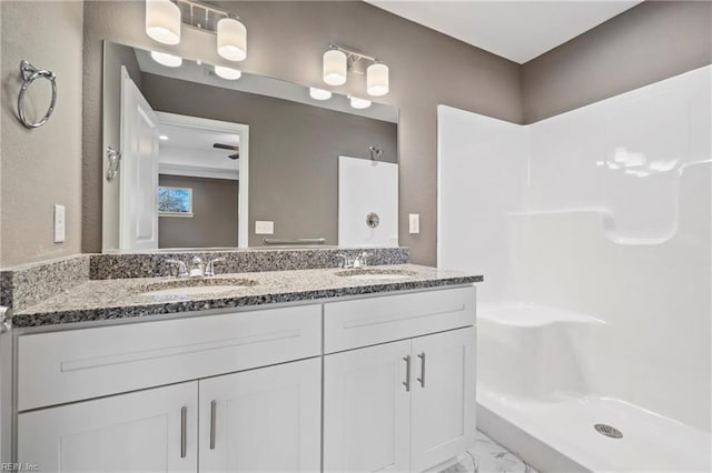 bathroom featuring vanity and a shower