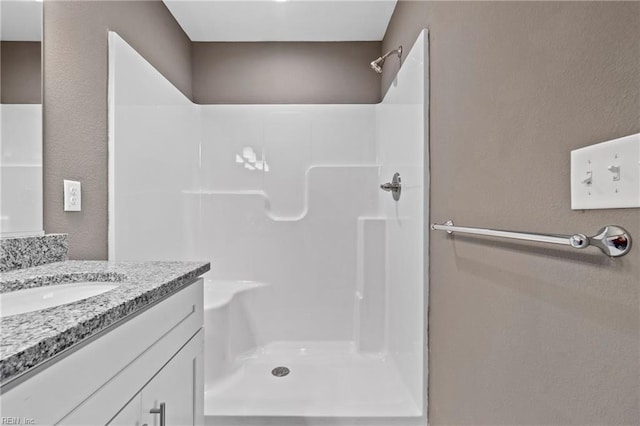 bathroom with vanity and walk in shower