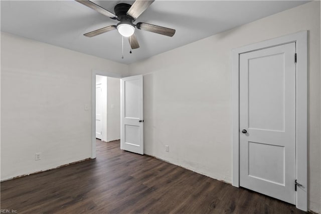 unfurnished bedroom featuring dark hardwood / wood-style floors and ceiling fan