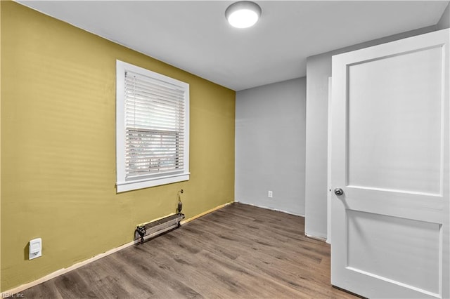 unfurnished room featuring hardwood / wood-style flooring