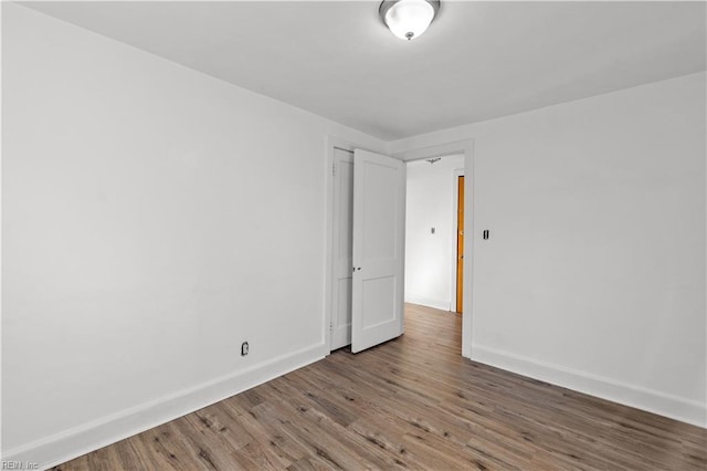 empty room with hardwood / wood-style flooring