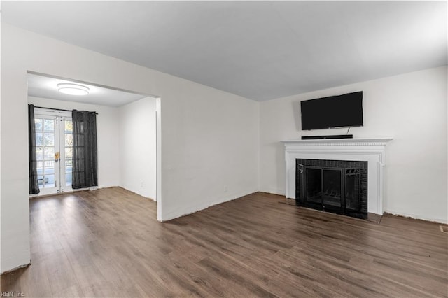 unfurnished living room featuring dark wood-type flooring and french doors