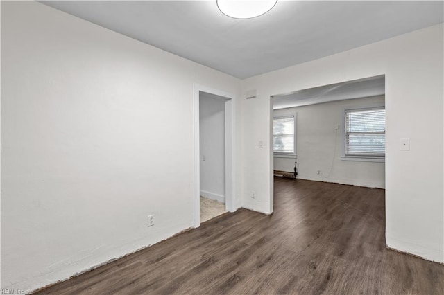 spare room featuring dark hardwood / wood-style flooring