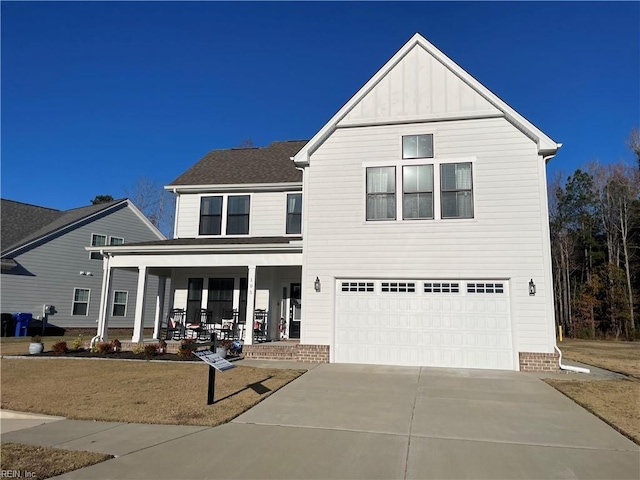 front of property with covered porch and a garage