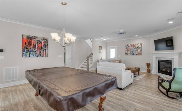 game room with light wood-type flooring, crown molding, billiards, and a chandelier