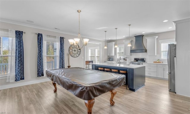 recreation room featuring a wealth of natural light, light hardwood / wood-style flooring, and pool table