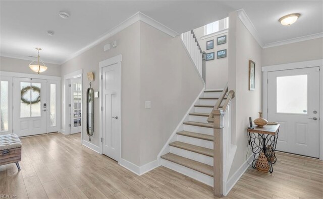 foyer entrance featuring light wood-type flooring and ornamental molding