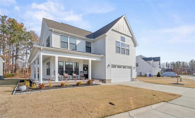 view of front of house featuring covered porch, central AC unit, and a garage