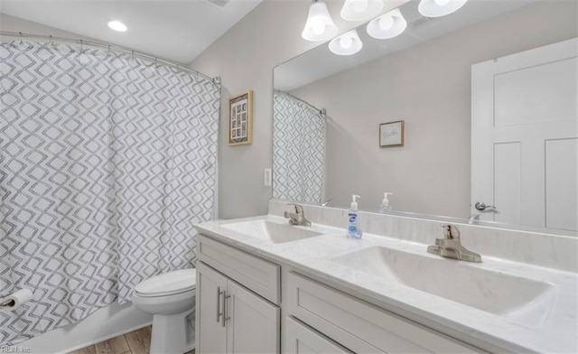 full bathroom featuring hardwood / wood-style flooring, shower / bath combo, toilet, and vanity