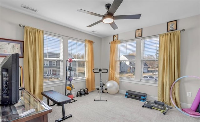 workout room featuring ceiling fan and carpet floors